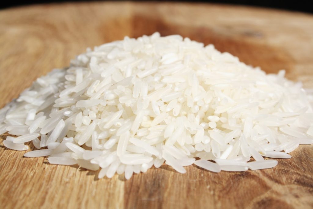 a-pile-of-rice-sitting-on-top-of-a-wooden-cutting-board-y0seigel2l4